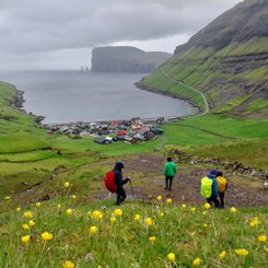 Eine Wandergruppe steigt hinunter nach Tjornuvik auf den Färöer-Inseln